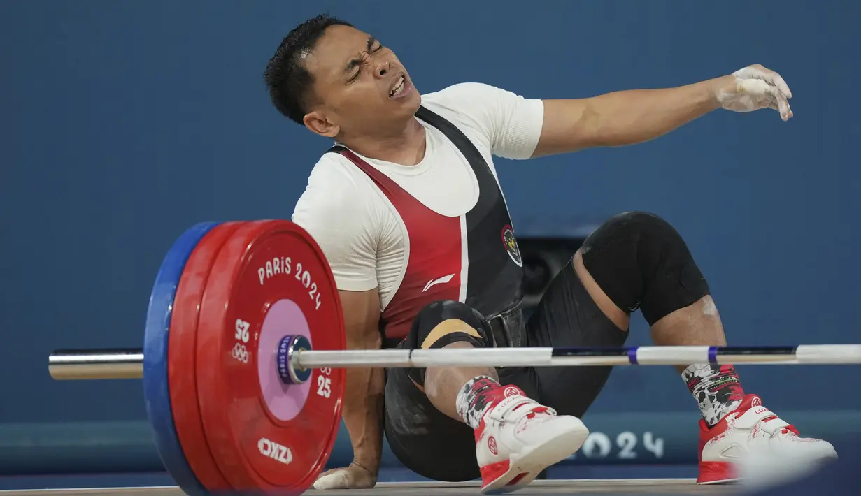 Hasil ini membuat Eko tak berhasil melanjutkan tradisi medali Olimpiade. (AP Photo/Kin Cheung)