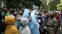 Ratusan warga berbondong-bondong datang ke Kantor Baznas Kabupaten Bogor, Jawa Barat untuk menerima paket sembako yang kabarnya akan dibagikan lembaga pengelolaan zakat itu, Senin (20/4/2020) pagi. (Liputan6.com/Achmad Sudarno)