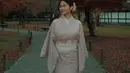 Azizah memilih mengenakan kimono warna pink polos tanpa motif. Dipadukan inner putih bermotif kerah tinggi. [@azizahsalsha_]