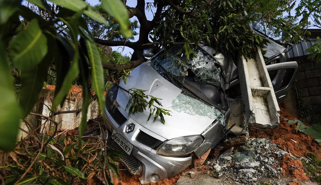 Sebuah mobil terkubur dalam lumpur setelah tanah longsor yang disebabkan oleh hujan lebat di Belo Horizonte, Brasil (27/1/2020). Lebih dari 30.000 orang terlantar akibat hujan lebat di Brasil tenggara yang juga menewaskan lebih dari 50 orang. (AP Photo/Gustavo Andrade)