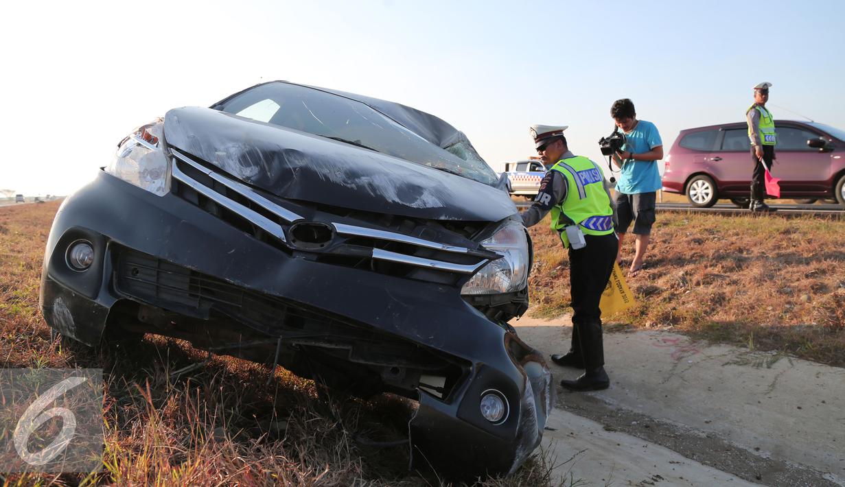 Petugas kepolisian memeriksa kendaraan yang mengalami kecelakaan di Tol Cipali, Jawa Barat, Senin (13/7/2015). Mobil bernomor polisi D 1807 PB tersebut menabrak penanda jalan di Km 149+800. (Liputan6.com/Herman Zakharia)