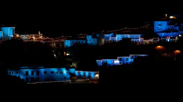 Lampu berwarna biru dinyalakan untuk menandai awal musim Natal di Juzcar, Selatan Spanyol, 2 Desember 2016. Semua bangunan di desa ini sengaja dicat berwarna biru untuk mempromosikan premier film baru "Smurfs: the lost village". (REUTERS/Jon Nazca)