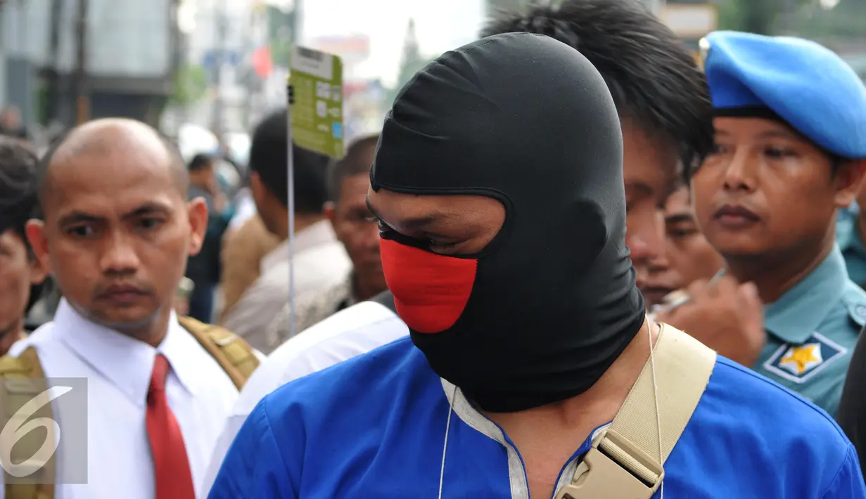 Tersangka JL mengikuti proses rekonstruksi pembunuhan aktivis Jopi Peranginangin, Kemang, Jakarta, Kamis (11/06/2015). Proses rekonstruksi tersebut terdiri dari 31 reka adegan yang diperankan oleh tersangka dan saksi-saksi. (Liputan6.com/Andrian M Tunay)