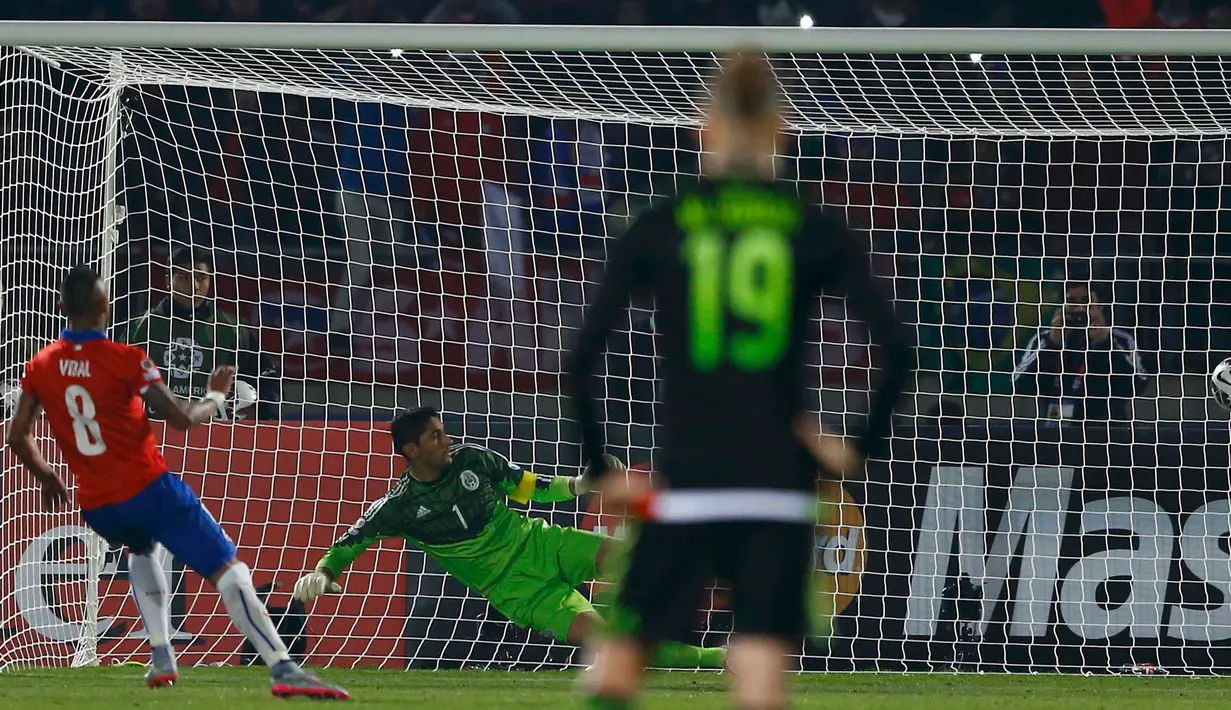 Kiper Meksiko, Jose Corona gagal menghalau tendangan gelandang Chile Arturo Vidal di pertandingan Copa America 2015 di National Stadium, Santiago, Chile, (16/6/2015). Chile bermain imbang 3-3 dengan Meksiko. (REUTERS/Ivan Alvarado)