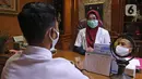 drg. Ayusha berbincang dengan pasien di salah satu klinik di kawasan Pulo Gadung, Jakarta, Rabu (22/4/2020). Di tengah pandemi COVID-19 seperti sekarang ini, drg. Ayusha akan mengenakan alat perlindungan diri (APD) saat memeriksa pasien. (Liputan6.com/Herman Zakharia)