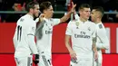 Gelandang Real Madrid, Marcos Llorente berselebrasi dnegan rekannya setelah mencetak gol ke gawang Girona pada leg kedua perempat final Copa del Rey di Stadion Municipal de Montilivi, Kamis (31/1). Real Madrid berhasil menang 3-1. (PAU BARRENA/AFP)