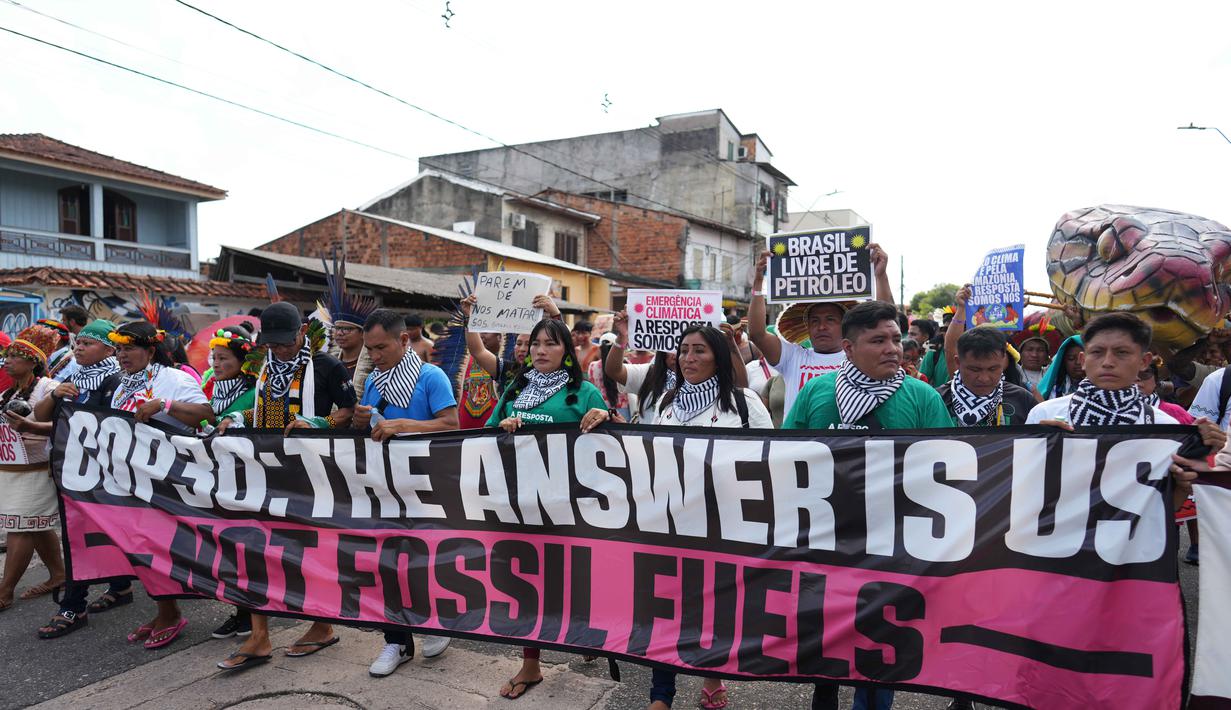 Aksi ini juga menyuarakan desakan agar hak-hak mereka atas tanah ulayat diakui dan dilindungi secara penuh dalam kebijakan iklim global. Tampak dalam foto, para aktivis berdemonstrasi dalam aksi protes di tengah-tengah perhelatan Konferensi Tingkat Tinggi Perubahan Iklim PBB (COP30), di Belem, Brasil, Senin 17 November 2025. (AP Photo/Andre Penner)