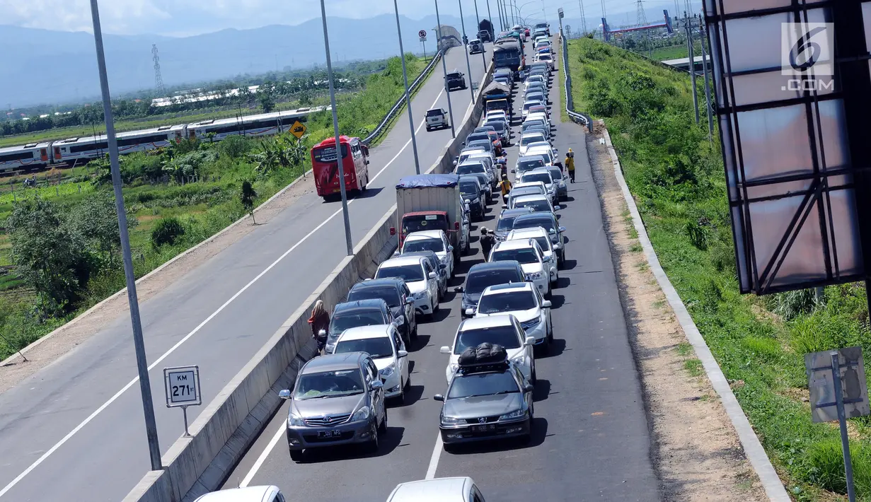 Sejumlah kendaraan antri menuju Simpang Tiga Keluar Tol Brebes, Jawa Tengah, Sabtu (23/12). Memasuki libur panjang Natal 2017, arus lalu lintas di Simpang Tiga Keluar Tol Brebes terlihat ramai lancar. (Liputan6.com/Helmi Fithriansyah)