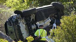 Mobil yang dikendarai Woods menabrak trotoar kemudian kehilangan kendali hingga keluar jalur, dan akhirnya jatuh ke lereng perbukitan. (Foto: AP/Marcio Jose Sanchez)