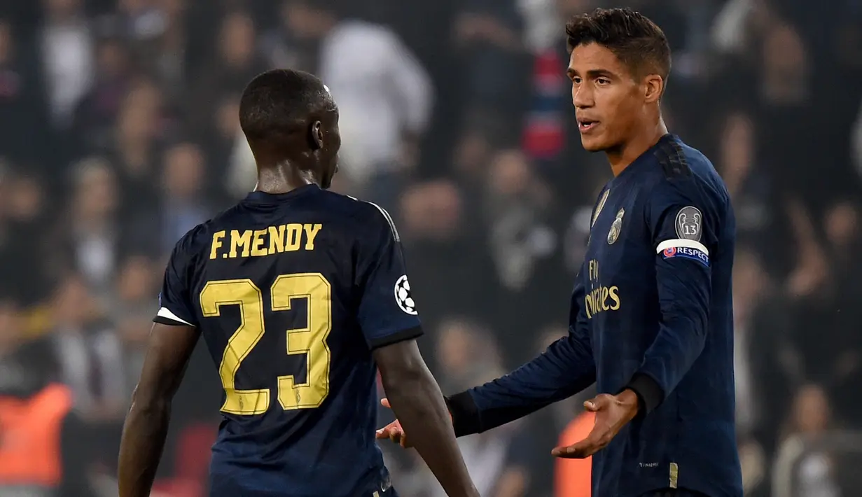 Reaksi bek Real Madrid, Raphael Varane dan rekan setimnya, Ferland Mendy pada laga Grup A Liga Champions melawan Paris Saint-Germain (PSG) di Parc des Princes, Rabu (18/9/2019). Real Madrid kalah telak dengan skor 0-3. (Lucas BARIOULET / AFP)