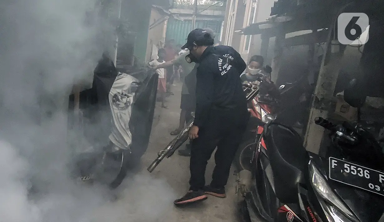 Petugas melakukan pengasapan (fogging) untuk memberantas perkembangbiakkan nyamuk Demam Berdarah Dengue (DBD) di pemukiman padat penduduk, Jakarta, Rabu (18/5/2022). Menghadapi musim pancaroba yang menjadi perkembangbiakkan nyamuk Aedes Agypty penyebab penyakit DBD, warga melakukan fogging di wilayah padat penduduk. (Liputan6.com/JohanTallo)