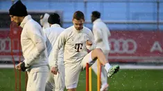 Gelandang Bayern Munchen #06 Joshua Kimmich (kanan) menghadiri sesi latihan saat hujan salju menjelang lanjutan Liga Champions 2023-2024, di Munich, Jerman selatan, Selasa (28/11/2023). (LUKAS BARTH / AFP)