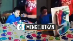Setelah bocah itu meniup lilin kue ulang tahun, ia justru membalik kue ulang tahun itu dengan sengaja.