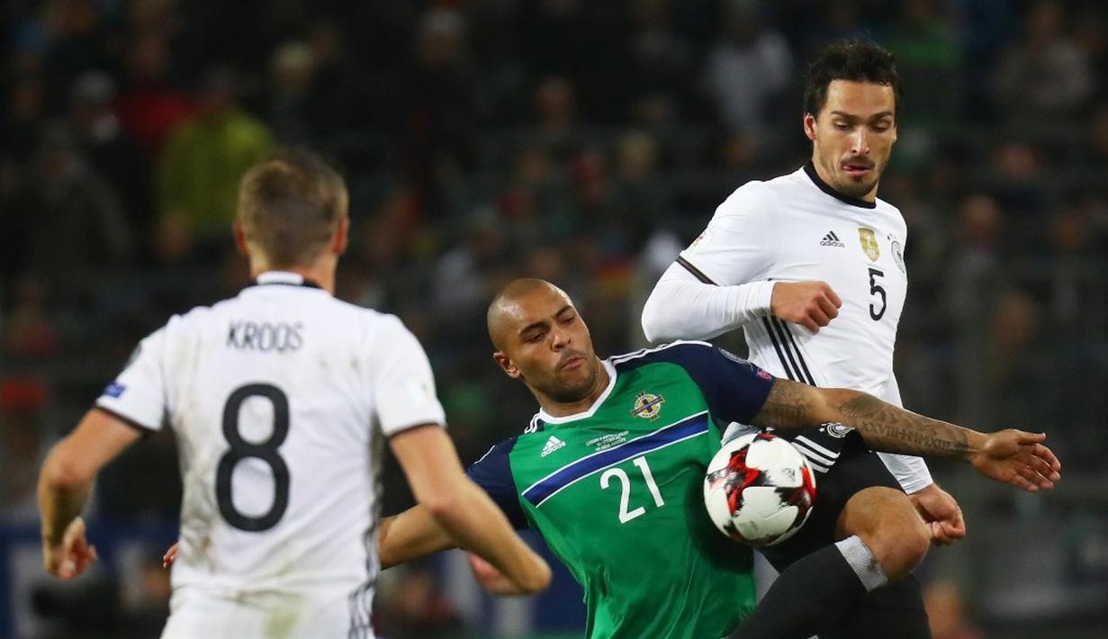 Striker Jerman, Mats Hummels (kanan), berebut bola dengan pemain Irlandia Utara, Josh Magennis, pada laga Grup C Kualifikasi Piala Dunia 2018 zona Eropa, di HDI-Arena, Hanover, Rabu (12/10/2016) dini hari WIB. (Reuters/Kai Pfaffenbach)