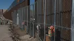 Pekerja menyelesaikan pembangunan tembok yang memisahkan AS dengan Meksiko, Rabu (25/1). Rencananya Trump Wall atau Tembok Trump akan dibangun di perbatasan AS dan Meksiko sepanjang 3.200 kilometer. (AP PHOTO)