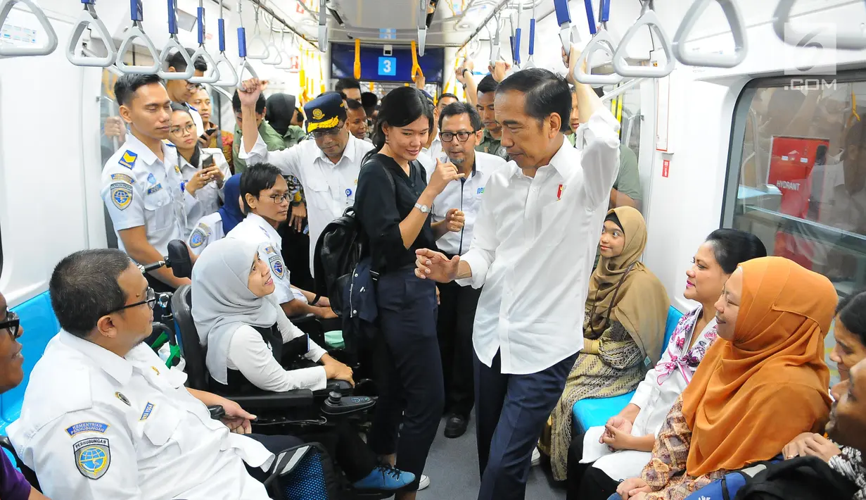 Presiden Joko Widodo berbincang dengan penyandang disabilitas saat menjajal MRT di Jakarta, Kamis (21/3). Jokowi didampingi Ibu Negara Iriana mencoba kembali kereta tersebut bersama disabilitas, dan artis Chelsea Islan. (Liputan6.com/Angga Yuniar)