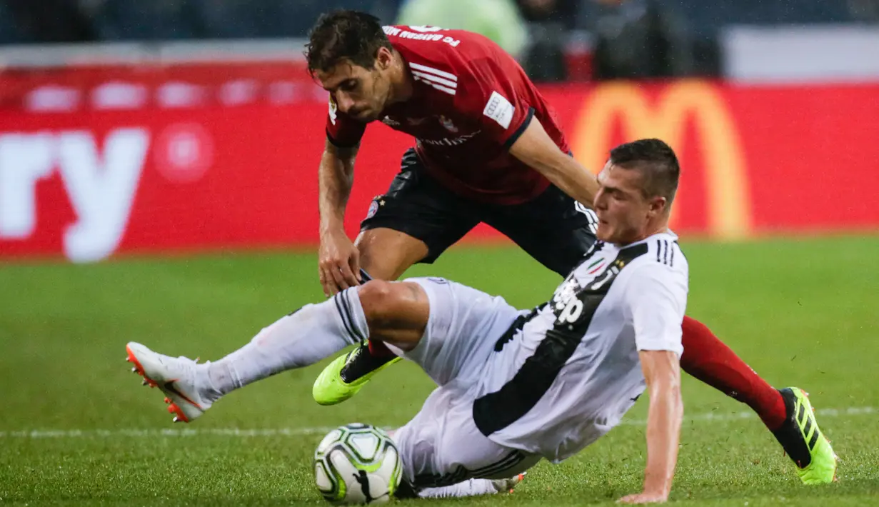 Pemain anyar Juventus, Andrea Favilli (kanan) memperebutkan bola dengan pemain Bayern Munchen Javi Martinez dalam International Champions Cup (ICC) 2018 di Lincoln Financial Field, Philadelphia, Amerika Seikat, Rabu (25/7). (Eduardo Munoz Alvarez/AFP)