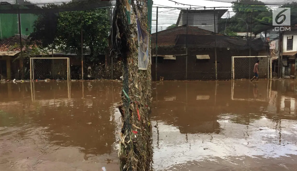 Sampah dan lumpur terlihat di lapangan futsal di kawasan Rawajati, Jakarta, Selasa (6/2). Banjir yang merendam kawasan tersebut menyebabkan lumpur dan sampah mengendap di setiap sudut sehingga mengganggu aktivitas warga. (Liputan6.com/Immanuel Antonius)