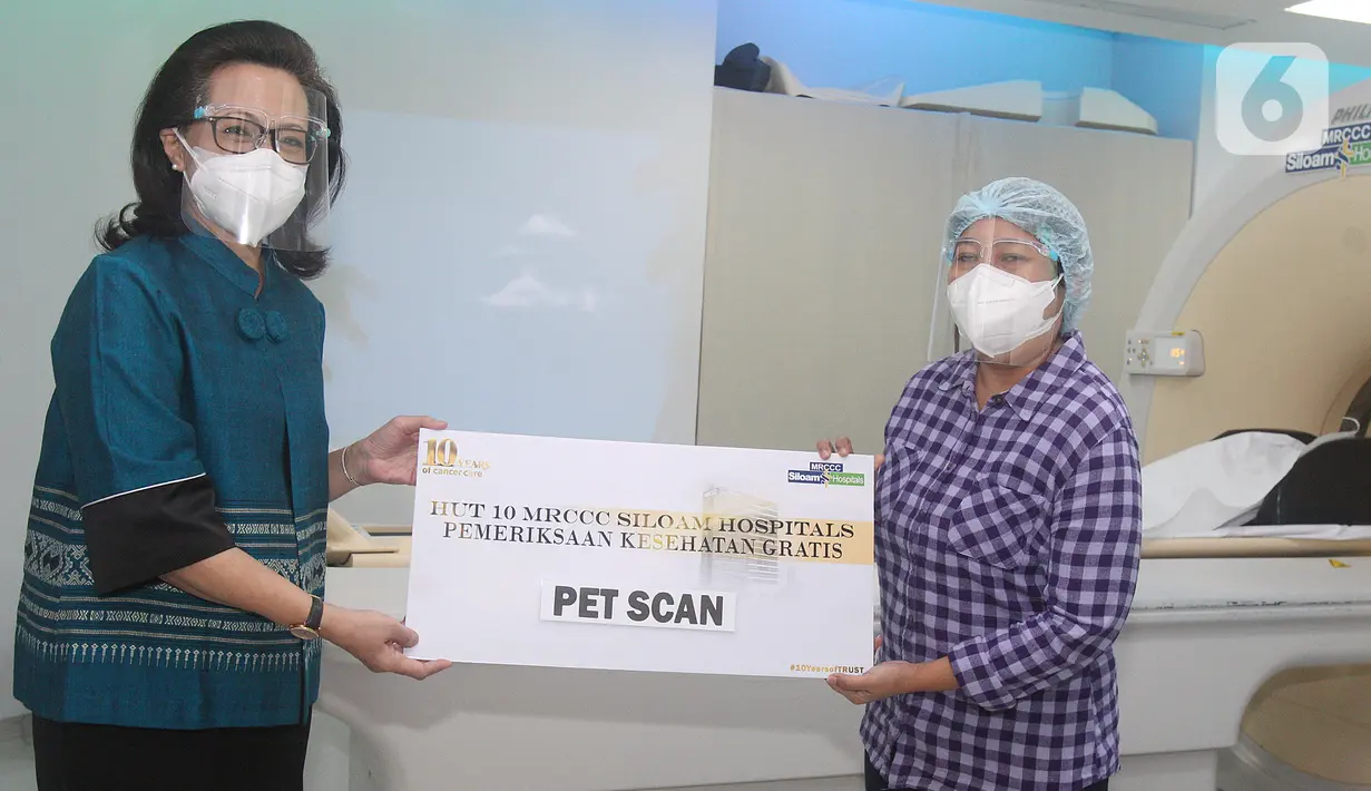 Direktur MRCCC Siloam dr. Adityawati Ganggaiswari, M.Biomed (kiri) memberikan voucher pemeriksaan Positron Emission Tomography - Computed Tomography (PET CT) bagi penyintas dan pasien kanker di Jakarta, Rabu (14/7/2021). Sebanyak 10 voucher diberikan kepada 10 pasien kanker. (Liputan6.com/HO/MRCCC)