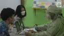 Petugas medis menjelaskan vaksinasi Covid-19 kepada siswa di SMUN 20 Jakarta, Kamis (1/7/2021). Target 1,3 juta anak di Jakarta disuntik vaksin Corona. (merdeka.com/Imam Buhori)