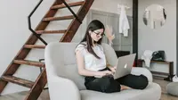 Ilustrasi mendengarkan lagu, musik. (Photo by Vlada Karpovich: https://www.pexels.com/photo/focused-woman-using-earphones-and-laptop-at-home-during-work-4050336/)