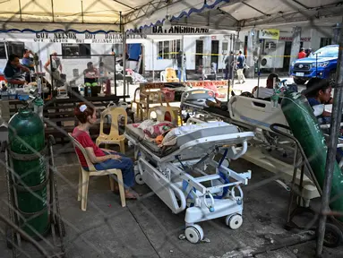 Pasien menunggu di luar rumah sakit yang rusak di Manay, Provinsi Davao Oriental, Filipina pada 11 Oktober 2025. (Jam STA ROSA/AFP)