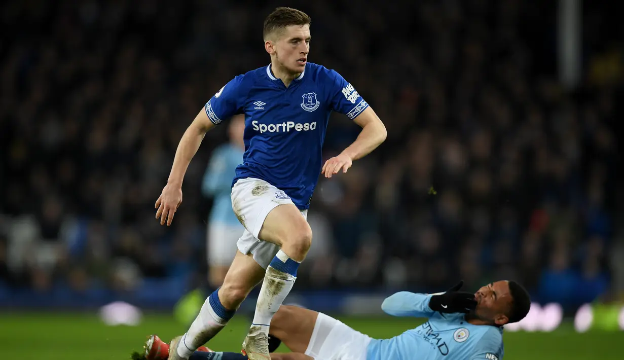 Aksi Gabriel Jesus menghadang Jonjoe Kenny pada laga lanjutan Premier League yang berlangsung di stadion Goodison Park, Liverpool, Kamis (7/2). Manchester City menang 2-0 atas Everton. (AFP/Paul Ellis)