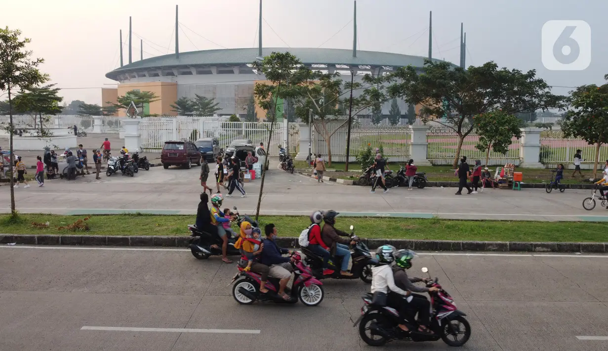 Foto udara memperlihatkan aktivitas warga di jalan lingkar kawasan Stadion Pakansari, Kabupaten Bogor, Jawa Barat, Minggu (28/6/2020). Meski area tersebut belum dibuka kembali, namun warga tetap masuk untuk melakukan beragam aktivitas di kawasan tersebut. (Liputan6.com/Helmi Fithriansyah)