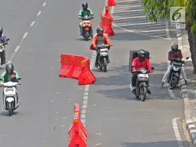 Pengendara sepeda motor melintasi jalur sepeda di Jalan MH Thamrin, Jakarta, Selasa (24/9/2019). Jalur sepeda yang mulai diuji coba pada 20 September 2019 lalu tersebut belum steril dari kendaraan bermotor. (Liputan6.com/Herman Zakharia)