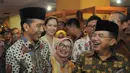 Jokowi dan JK tersenyum satu sama lain setelah memakai kopiah, Pasaraya Blok M, Jakarta, Kamis (2/10/2014) (Liputan6.com/Herman Zakharia)