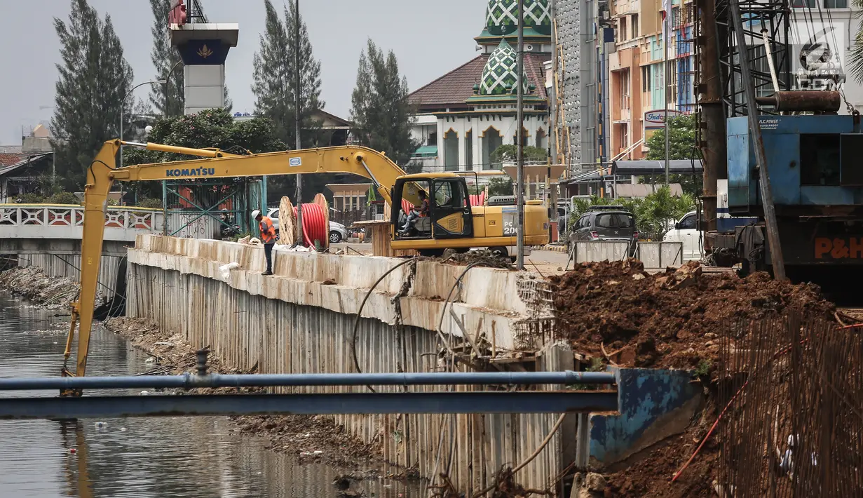 Sebuah eskavator diturunkan guna menyelesaikan pembangunan turap Kali Sunter Jakarta Utara, Selasa (18/12). Memasuki musim penghujan pembangunan turap terus dikebut. (Liputan6.com/Fery Pradolo)
