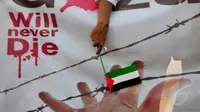 Hujan Deras Tak Halangi Aksi Dukung Palestina di Bundaran HI