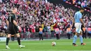 Kiper Arsenal, Aaron Ramsdale, melakukan selebrasi setelah berhasil menghalau tendangan penalti pemain Manchester City, Rodri, pada laga Community Shield di Stadion Wembley, London, Minggu (6/8/2023). Arsenal mengalahkan Manchester City 4-1 lewat adu penalti setelah bermain imbang 1-1 selama 90 menit. (AFP/Glyn Kirk)