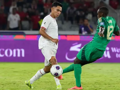Pemain timnas Indonesia, Marselino Ferdinan (kiri) berebut bola dengan Saud Abdulhamid (Arab Saudi) dalam pertandingan keenam Grup C pada putaran ketiga Kualifikasi Piala Dunia 2026 zona Asia di Stadion Gelora Bung Karno (GBK) Jakarta, Selasa (19/11/2024). (Liputan6.com/Herman Zakharia)