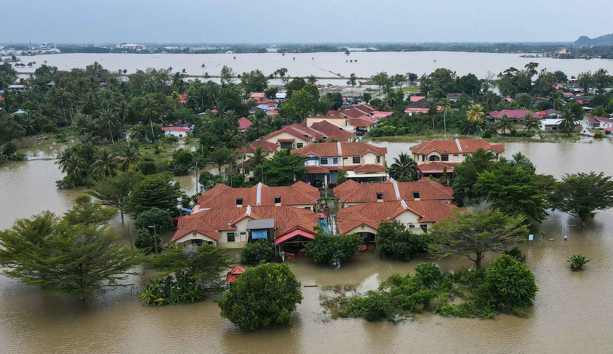 Hujan deras tanpa henti sejak awal pekan membuat aliran sungai di sejumlah wilayah Malaysia Utara meluap, hingga merendam beberapa kawasan permukiman. Tampak foto udara menunjukkan area permukiman yang terendam banjir di Kangar, negara bagian Perlis, Malaysia utara, pada Kamis 27 November 2025. (Mohd RASFAN/AFP)