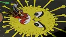 Pengendara motor melewati melewati grafiti virus corona yang dilukis di jalan selama penerapan lockdown nasional di Chennai, India, Senin (13/4/2020). Grafiti itu dibuat untuk meningkatkan kesadaran warga yang keluyuran keluar rumah saat lockdown karena pandemi virus corona. (Arun SANKAR/AFP)
