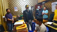 Tersangka penganiaya pengemudi ojek online ketika berada di ruang pemeriksaan Polresta Pekanbaru. (Liputan6.com/M Syukur)