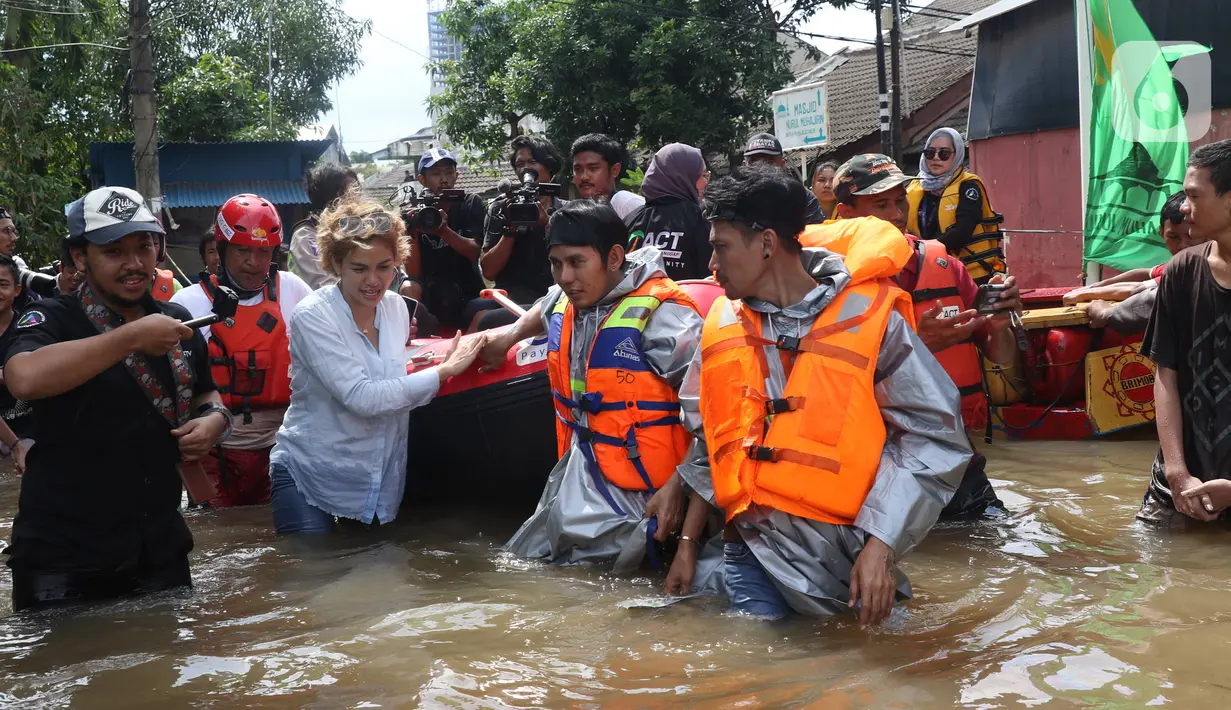 Artis Nikita Mirzani saat meninjau banjir di perumahan Ciledug Indah, Tangerang, Banten, Kamis (2/1/2020). Nikita menaiki perahu karet untuk melihat kondisi banjir di perumahan tersebut. (Liputan6.com/Angga Yuniar)