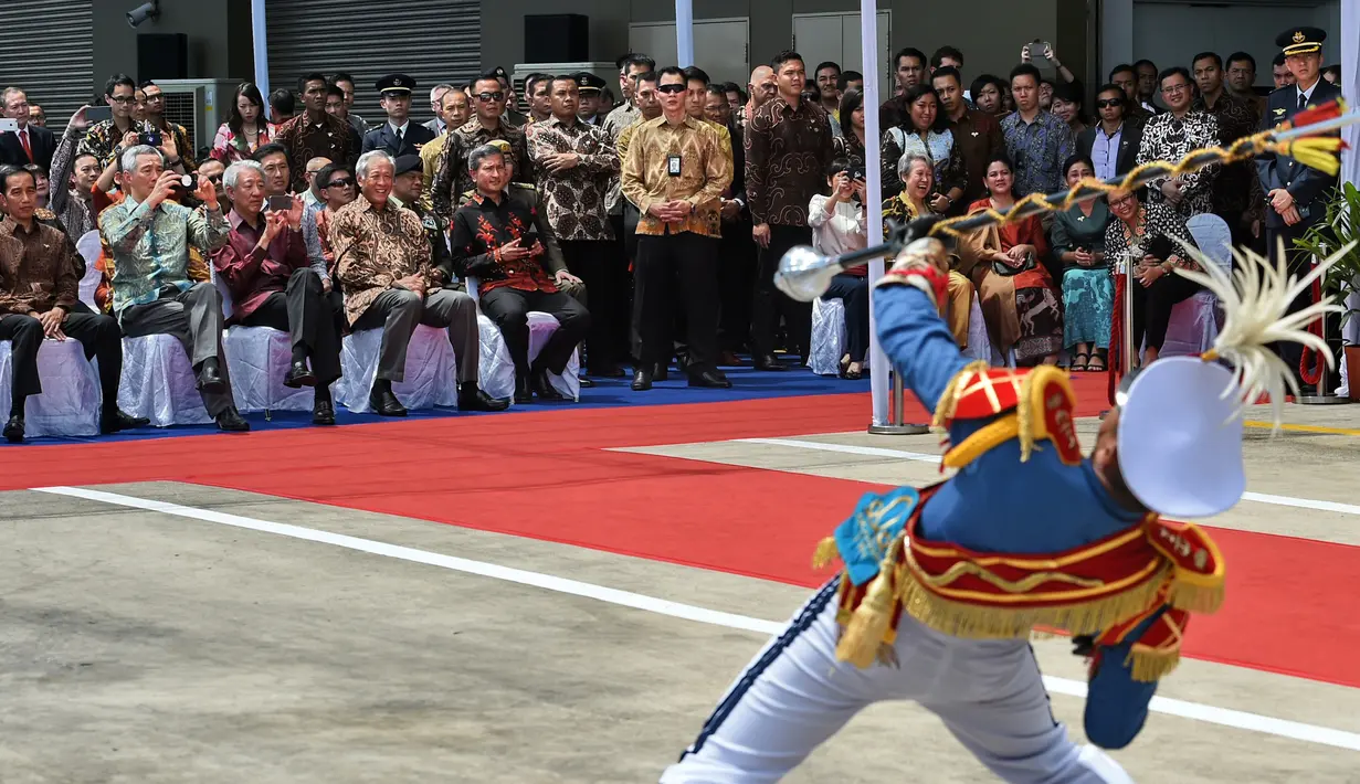 Presiden RI Joko Widodo dan PM Singapura Lee Hsien Loong menyaksikan personil band militer Indonesia tampil dalam peringatan 50 tahun hubungan bilateral Indonesia dan Singapura di Singapura, Kamis (7/9). (AFP Photo/Roslan Rahman)