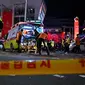 Staf medis merawat seseorang di atas tandu di distrik kehidupan malam populer Itaewon di Seoul, Korea Selatan, Minggu (30/10/2022) . Orang-orang dalam kerumunan di gang sempit itu dikabarkan sempat saling dorong. Selain berdesakan, banyak pula yang terinjak-injak hingga jumlah korban tewas dalam pesta Halloween di Itaewon melonjak. (Photo by JUNG YEON-JE / AFP)