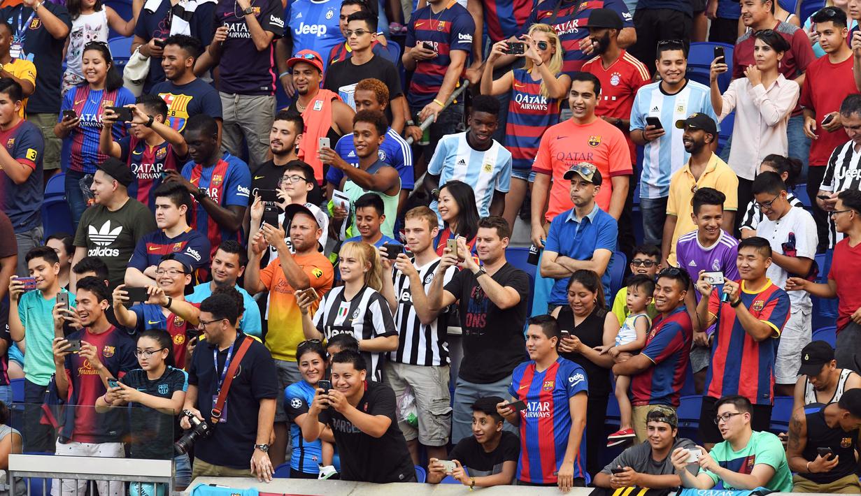 Fans Barcelona saat melihat tim kesayanganya menjalani latihan di Red Bull Arena di Harrison, New Jersey, (21/7). Barcelona akan berhadapan dengan Juventus pada ICC 2017. (AFP Photo/Jewel Samad) 