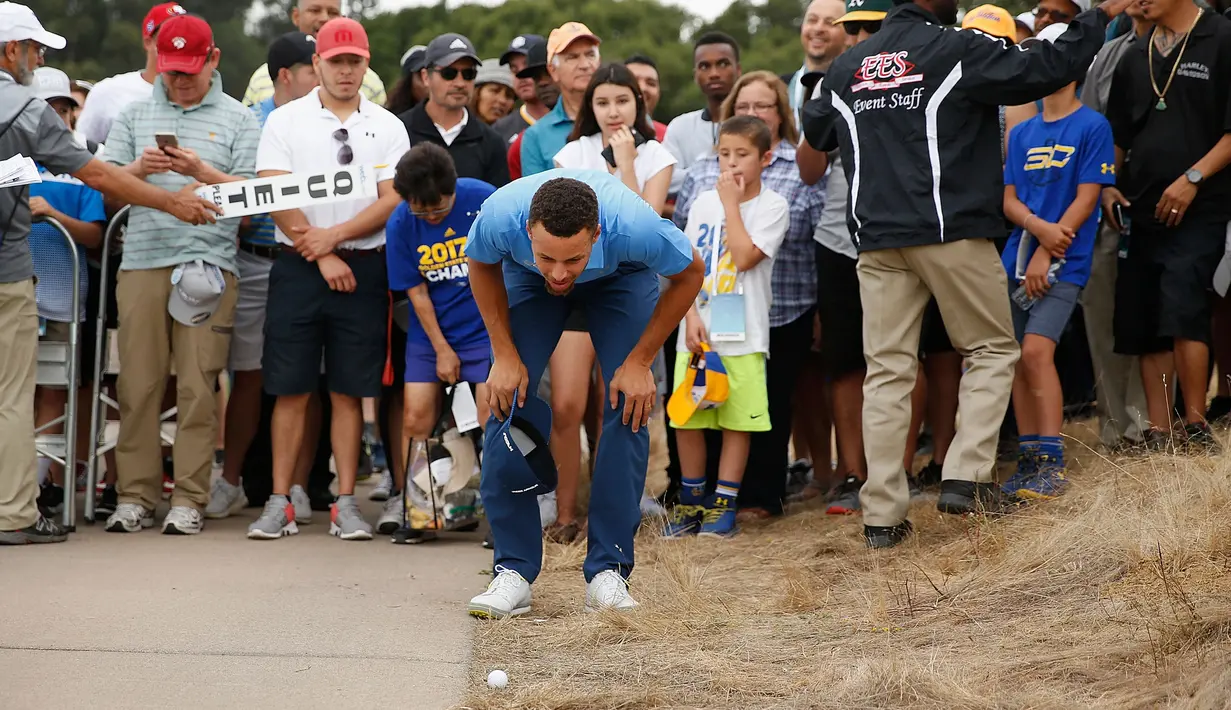 Stephen Curry memeriksa bolanya di lubang ketigabelas setelah melewatkan fairway saat putaran Ellie Mae Classic di TCP Stonebrae di Hayward, California (3/8). (Lachlan Cunningham/Getty Images/AFP)