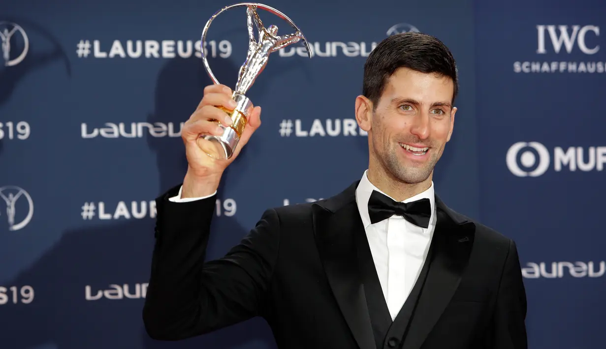 Petenis Serbia, Novak Djokovic berpose dengan trofi World Sportsman of the Year dalam ajang Laureus World Sports Awards 2019 di Monako, Senin (18/2). Djokovic mengalahkan Kylian Mbappe, LeBron James, Luka Modric dan Lewis Hamilton. (AP/Claude Paris)
