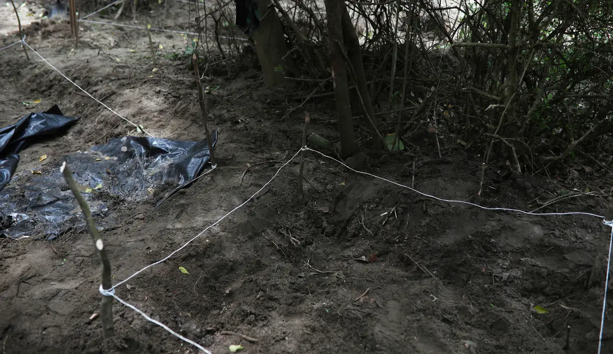 Pihak berwenang menutup area kuburan massal rahasia yang ditemukan di Arbolillo, negara bagian Veracruz, Meksiko, Jumat (7/9). Jaksa penuntut dari pengadilan Mekssiko menyebut penemuan tersebut berasal dari laporan seorang saksi. (AP/Felix Marquez)