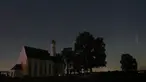 Sebuah meteor melintas di tengah langit malam selama hujan meteor tahunan Perseid di belakang gereja ziarah Sankt Coloman, barat daya Jerman, Minggu (12/8). Puncak hujan meteor terjadi pada 11-12 Agustus dan 12-13 Agustus. (KARL-JOSEF HILDENBRAND/DPA/AFP)