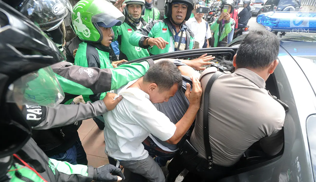 Petugas kepolisian mengamankan tiga terduga copet menuju Mapolda Metro Jaya di Jalan Jenderal Sudirman, Jakarta (2/4). (Merdeka.com/Arie Basuki)