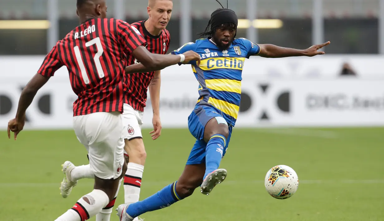 Penyerang Parma, Gervinho mengontrol bola dari kawalan Penyerang AC Milan, Rafael Leao pada pertandingan lanjutan Liga Serie A Italia di Stadion San Siro di Milan, Italia (15/7/2020). AC Milan menang telak 3-1 atas Parma. (AP Photo/Luca Bruno)