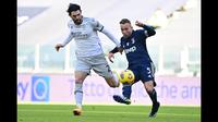 Pemain Juventus, Arthur (kanan) berusaha melewati hadangan pemain Bologna dalam laga lanjutan Liga Italia di Stadion Allianz, Turin, Minggu (24/1/2021). (Foto: AFP/Miguel Medina)