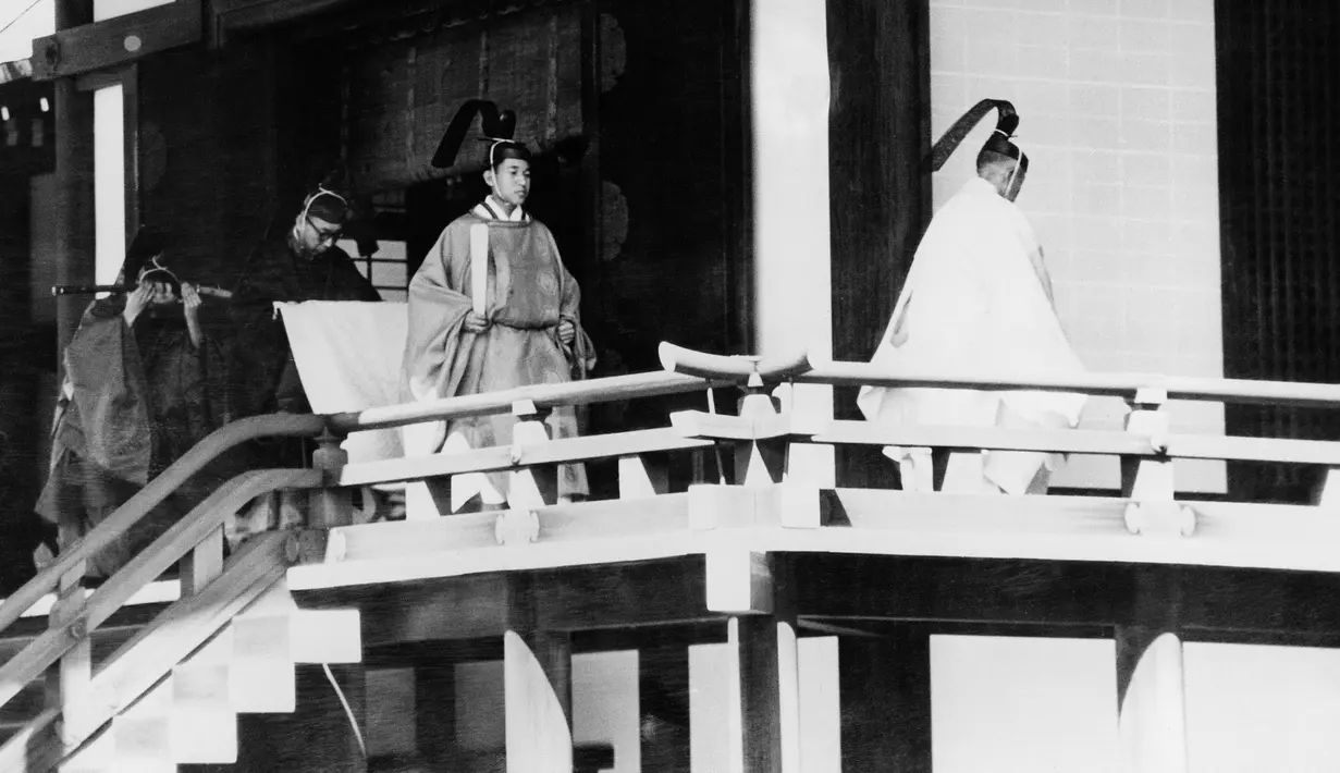 Putra Mahkota Jepang Akihito (kedua kanan) dibantu oleh seorang pejabat dari Badan Rumah Tangga Kekaisaran saat dia berjalan ke tempat suci Shinto di dalam Istana Kerajaan untuk menghadiri pernikahannya pada 10 April 1959. (AFP Photo)