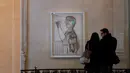 Pengunjung memperhatikan lukisan berjudul L'artiste deviant sa toile karya Pablo Picasso dalam pameran 'Guernica' di Museum Picasso, Paris, Prancis, Jumat (23/3). Pameran berlangsung dari 27 Maret hingga 29 Juli 2018. (AP Photo/Christophe Ena)